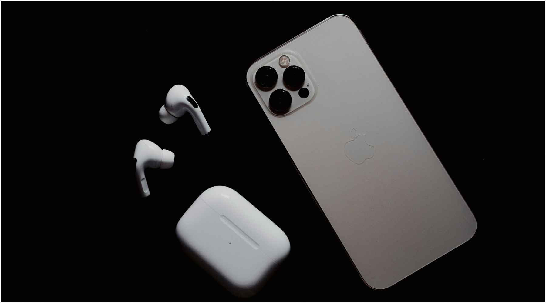Iphone and Airpods on the black background